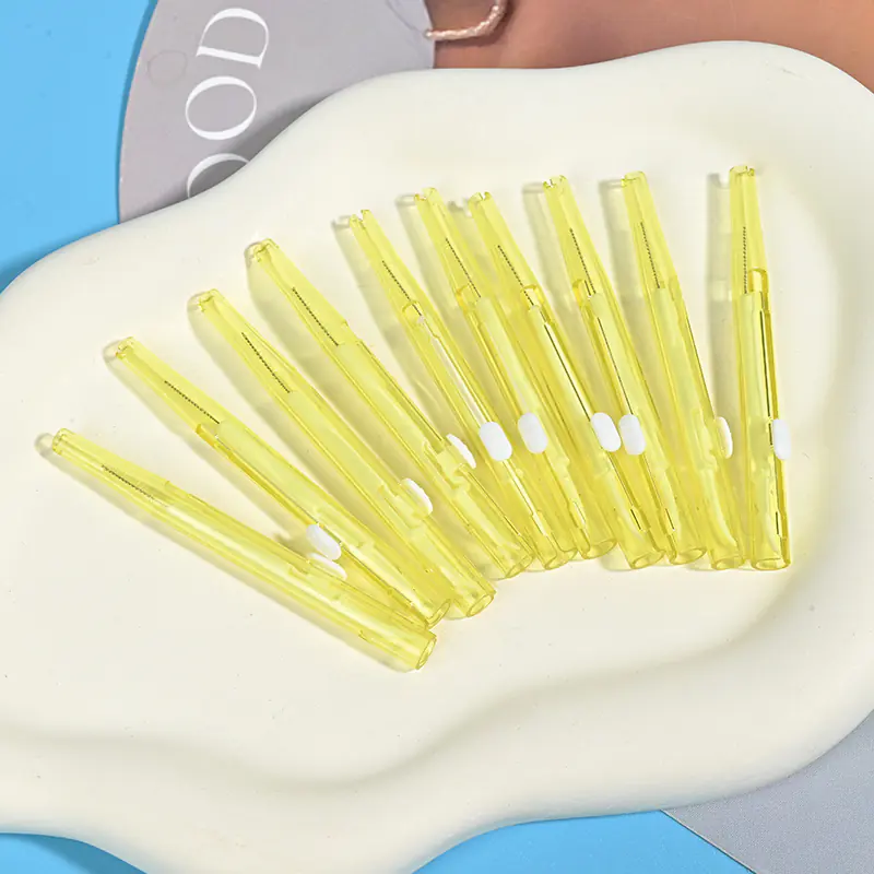 Push-pull type interdental brushes with yellow transparent handles, compact sliding design for easy storage and hygiene, suitable for dental care brands and B2B wholesale supply.