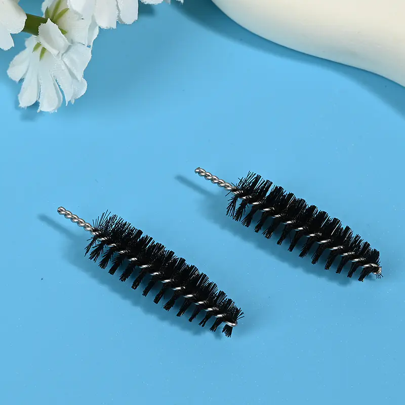 Black mascara brush heads with dense spiral bristles and twisted metal wire core, designed for professional eyelash application, OEM manufacturing, and bulk B2B cosmetic supply.