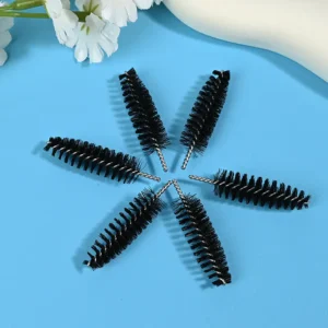 Black mascara brush heads with dense spiral bristles and twisted metal wire core, designed for professional eyelash application, OEM manufacturing, and bulk B2B cosmetic supply.