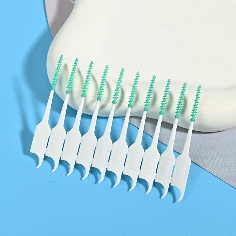 close-up of green silicone interdental brushes arranged in a row