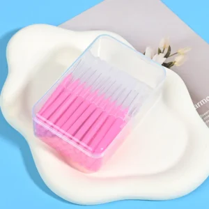 Clear plastic storage box of pink interdental brushes - bulk pack with protective caps for hygienic storage and resale