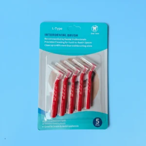 Five pieces red L-curved interdental brushes packed in printed paper blister retail card on plain light blue background