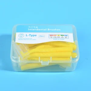 Close-up transparent plastic box filled with yellow L-type interdental brushes, bilingual Korean English label with full ISO size color specification chart on solid light blue background