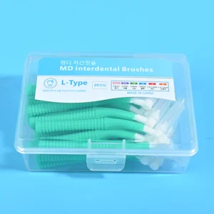 Close-up of transparent plastic box filled with green L-type MD interdental brushes, bilingual Korean English label with full ISO size chart on solid blue background