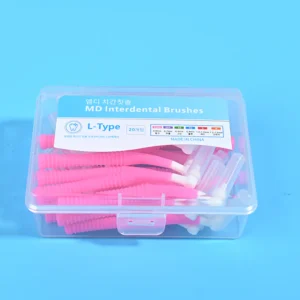 Close-up front view of clear plastic box filled with pink L-type MD interdental brushes, bilingual Korean English label with full ISO size chart on blue background