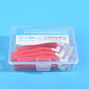 Close-up transparent plastic box filled with red L-type MD interdental brushes, bilingual Korean English label with full ISO size chart on blue background