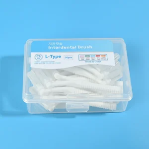 Clear plastic storage box full of white L-curved interdental brushes with bilingual Korean English sticker on solid bright blue background