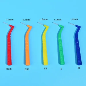 Five color coded L-type interdental brushes size comparison marked with 0.6mm/0.7mm/0.8mm/1.0mm/1.2mm ISO dimension on blue background