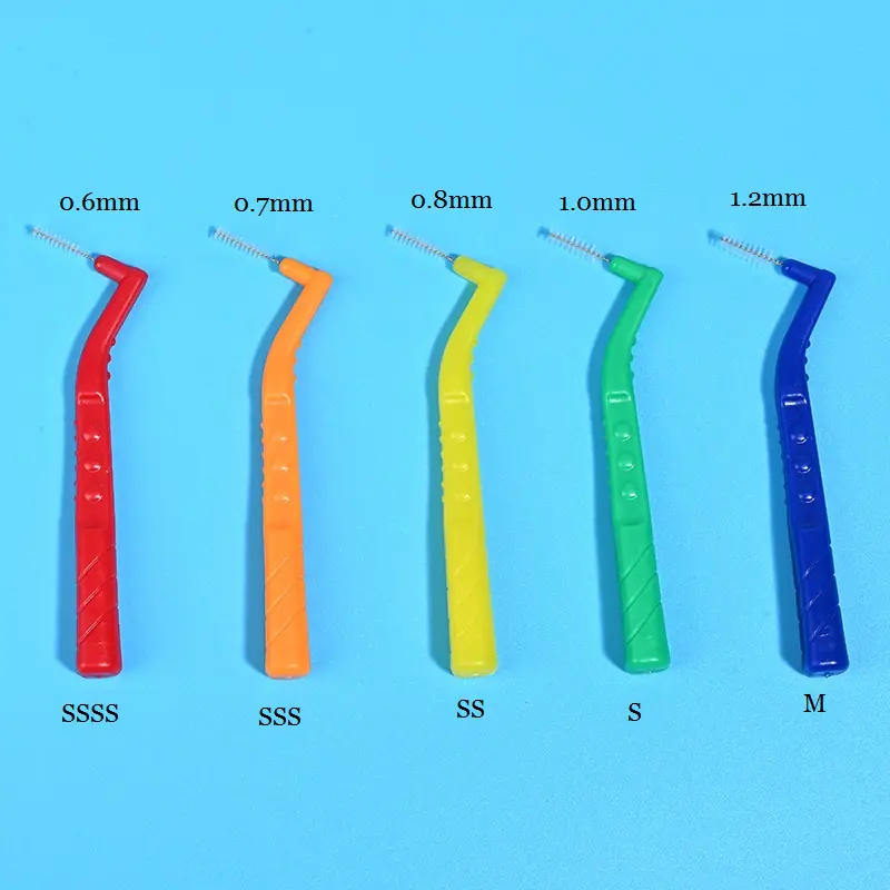 Five color coded L-type interdental brushes size comparison marked with 0.6mm/0.7mm/0.8mm/1.0mm/1.2mm ISO dimension on blue background