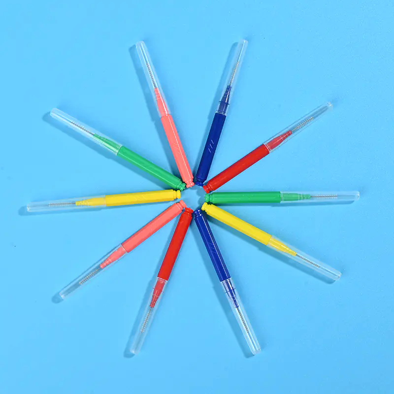 Rainbow assorted color straight I-type interdental cleaners arranged radial star shape on plain solid blue background