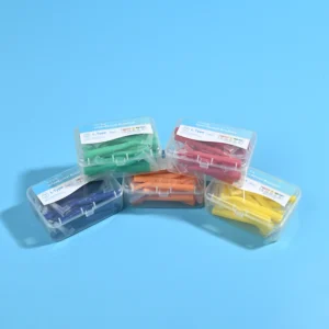 Stacked five assorted color clear plastic boxes of L-type MD interdental brushes on solid blue background, full color set wholesale display