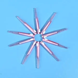 Transparent pink sliding retractable interdental brushes arranged radial star shape on solid light blue background
