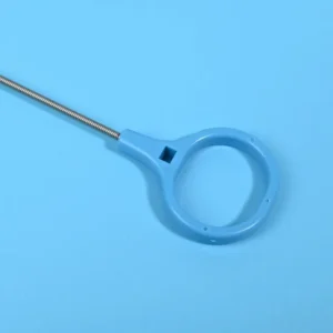 Close-up of blue plastic finger loop handle connected to stainless steel shaft of dilator cleaning brush, ergonomic pull ring for brush extraction operation